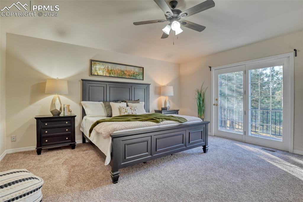 Image 26 of 44: Bedroom with light colored carpet, access to exterior, and a ceiling fan