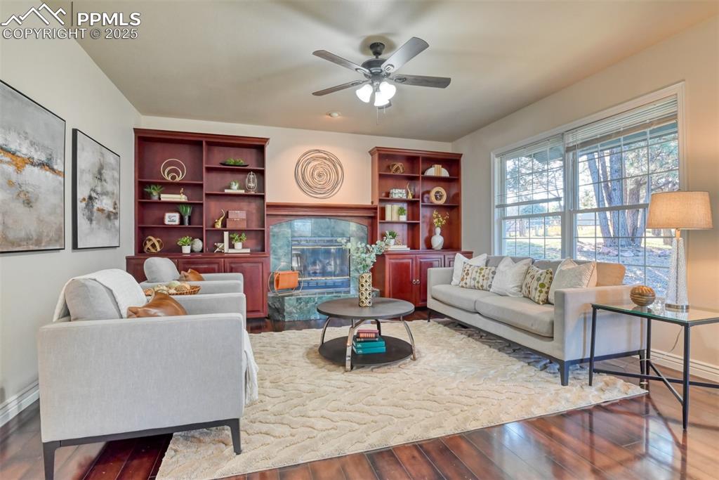 Image 5 of 44: Living room featuring a tile fireplace, dark wood-type flooring, and ceilin