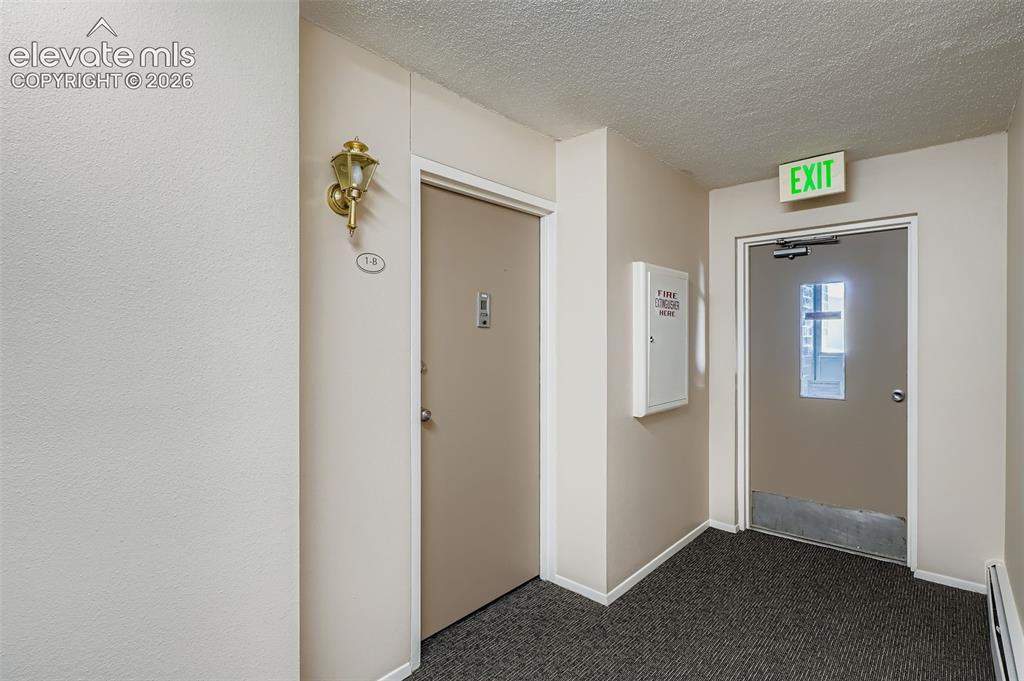 Image 10 of 27: Front entrance of condo from elevator