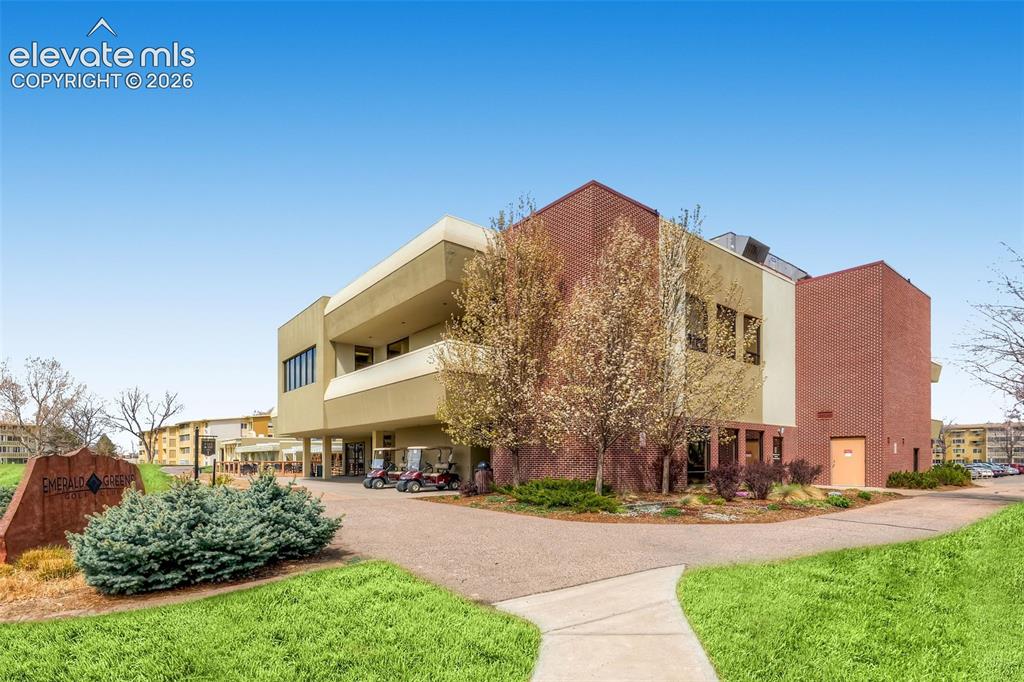 Image 15 of 27: Multi-story building featuring brick and stucco exterior finishes