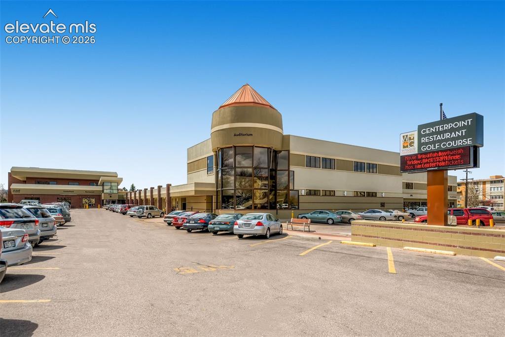 Image 20 of 27: Commercial building featuring a prominent circular architectural element wi