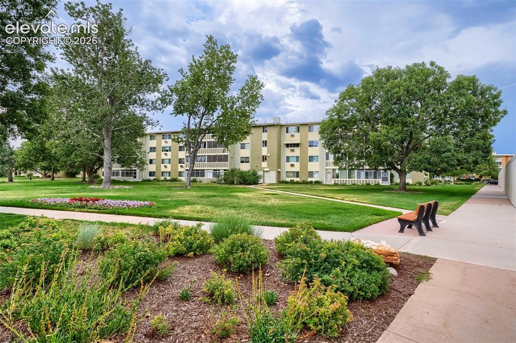 Image 27 of 27: Expansive green space featuring mature trees, manicured lawns, and colorful