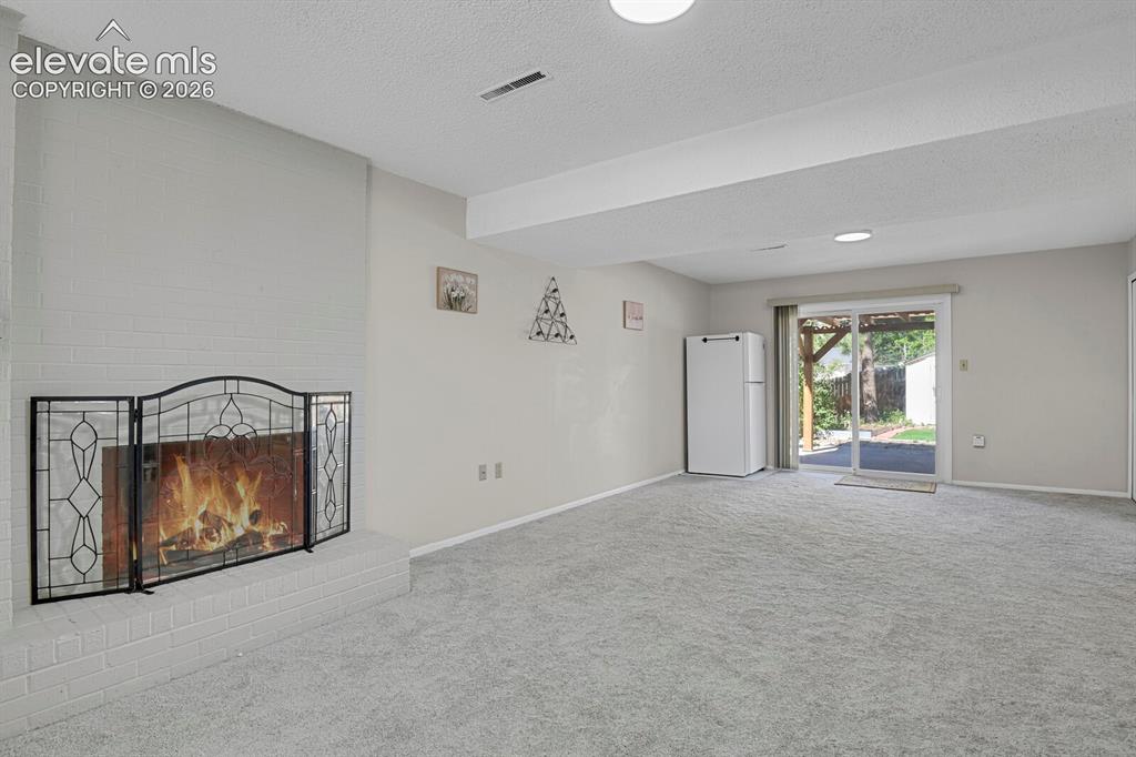 Image 25 of 31: Spacious recreation room featuring neutral carpeting, recessed ceiling ligh