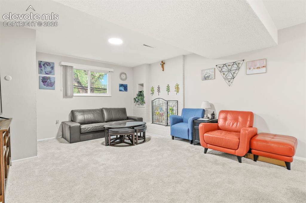 Image 26 of 39: Spacious room featuring light gray carpeting, neutral wall paint, a window 
