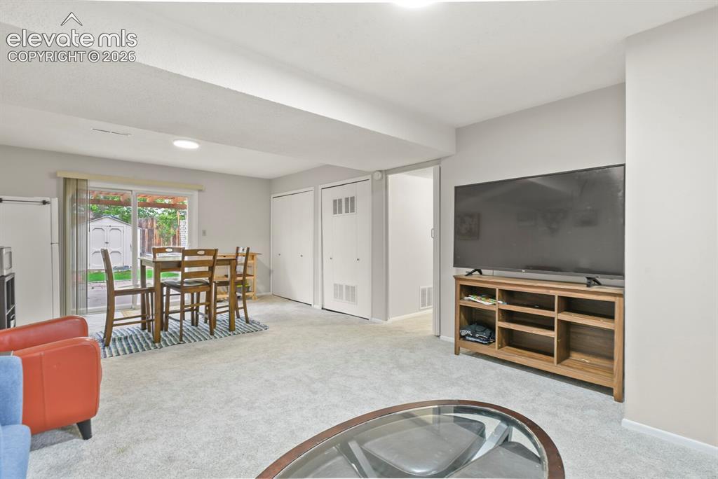 Image 29 of 39: Carpeted interior space featuring light gray walls and recessed lighting