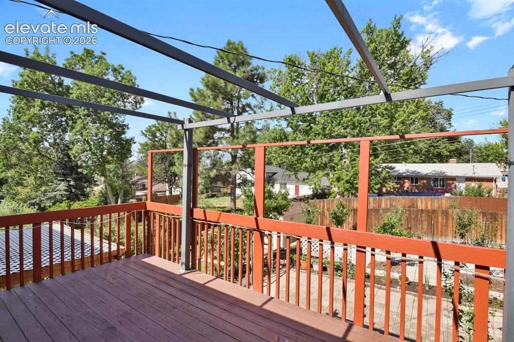 Image 30 of 31: Expansive composite deck featuring rich wood-finish flooring, horizontal me