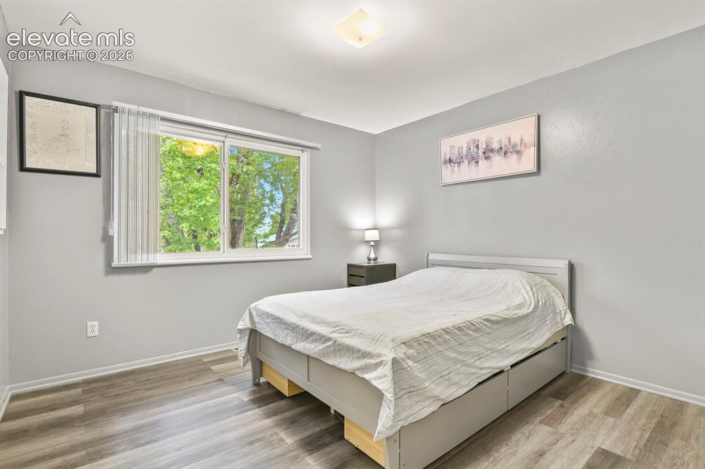 Image 8 of 31: Spacious interior featuring wood-finish flooring, a contemporary window wit