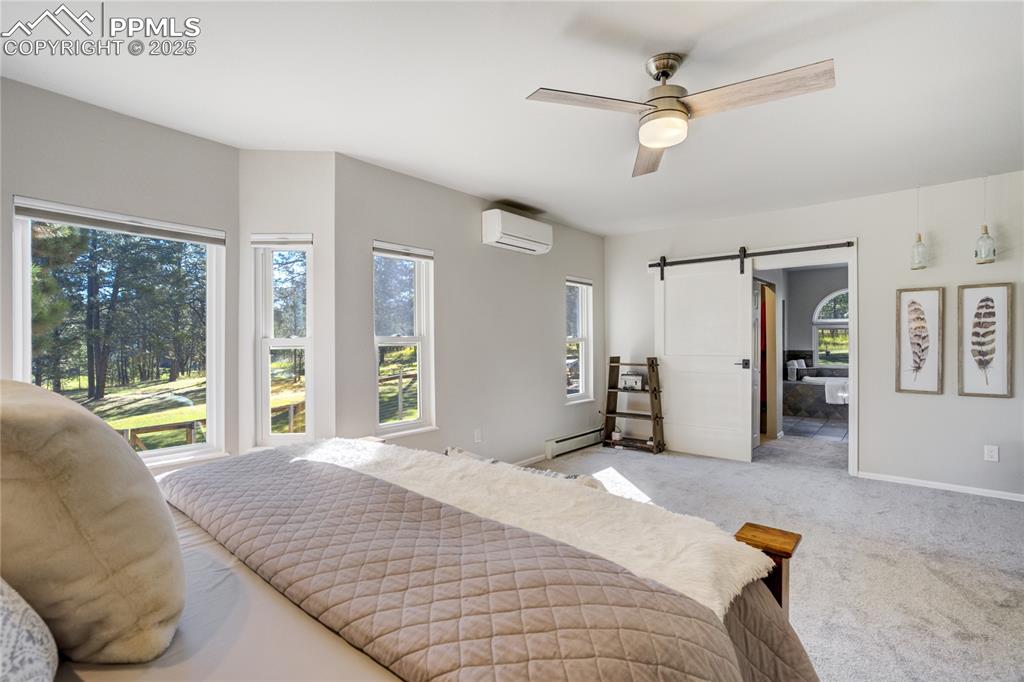 Image 18 of 50: Main level primary suite features dual closets and private ensuite