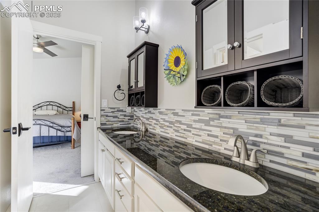 Image 30 of 50: Upper Level full bath featuring jack-n-jill entry dual sinks, granite count
