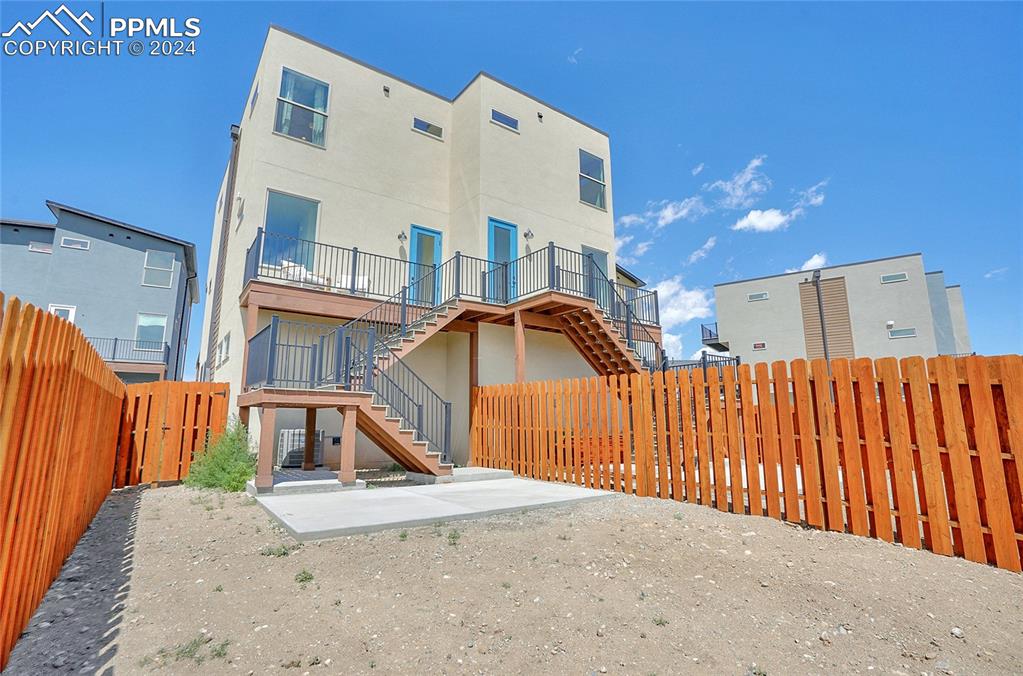 Image 17 of 24: Back of house with a patio area
