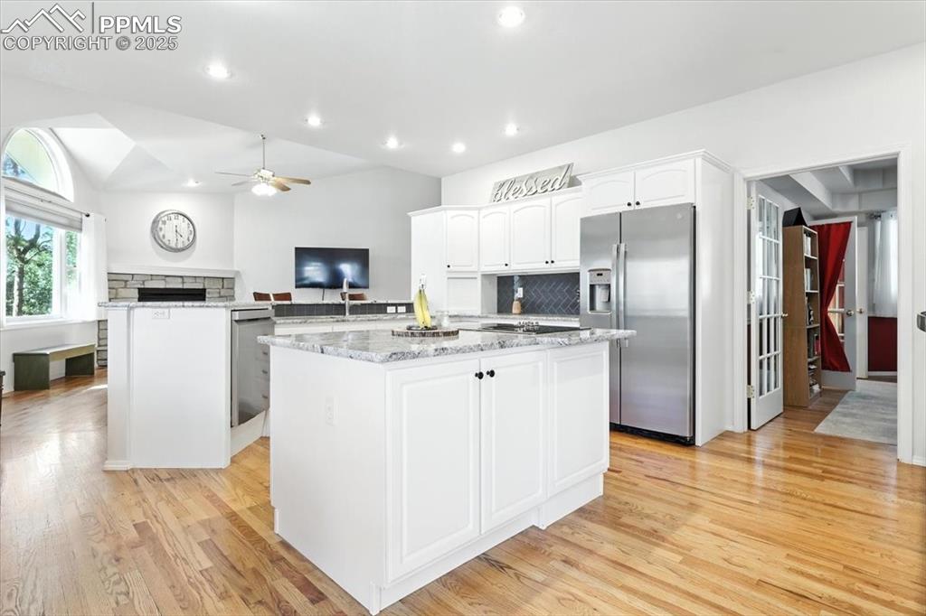 Image 13 of 45: Kitchen featuring appliances with stainless steel finishes, a kitchen islan