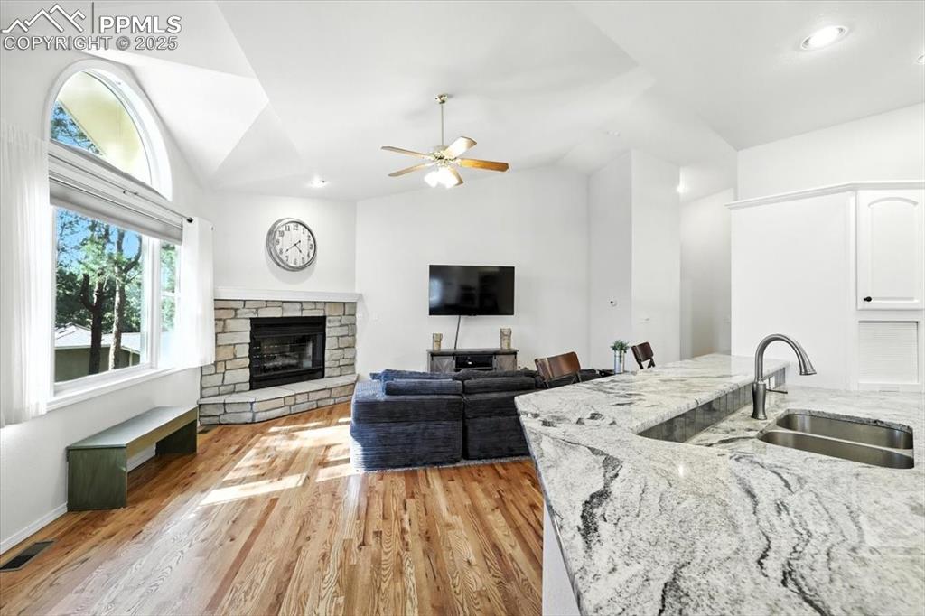 Image 18 of 45: Living area featuring lofted ceiling, light wood finished floors, ceiling f