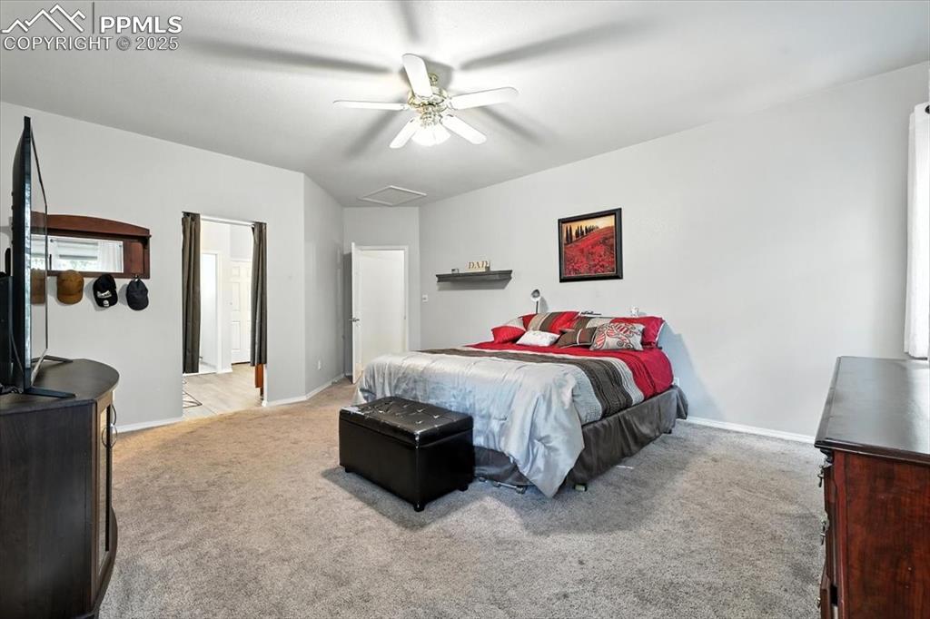 Image 19 of 45: Bedroom with light carpet and ceiling fan