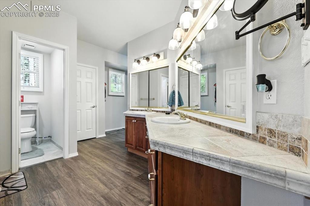 Image 21 of 45: Bathroom with vanity and wood finished floors