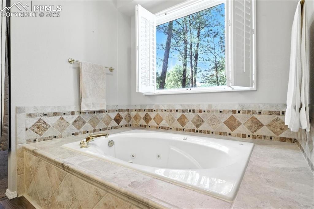 Image 23 of 45: Full bath featuring a tub with jets