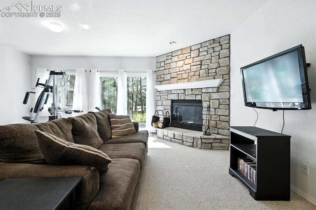 Image 29 of 45: Carpeted living area featuring a fireplace