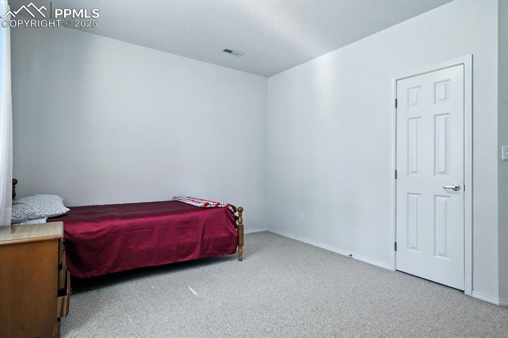 Image 34 of 45: Carpeted bedroom featuring baseboards