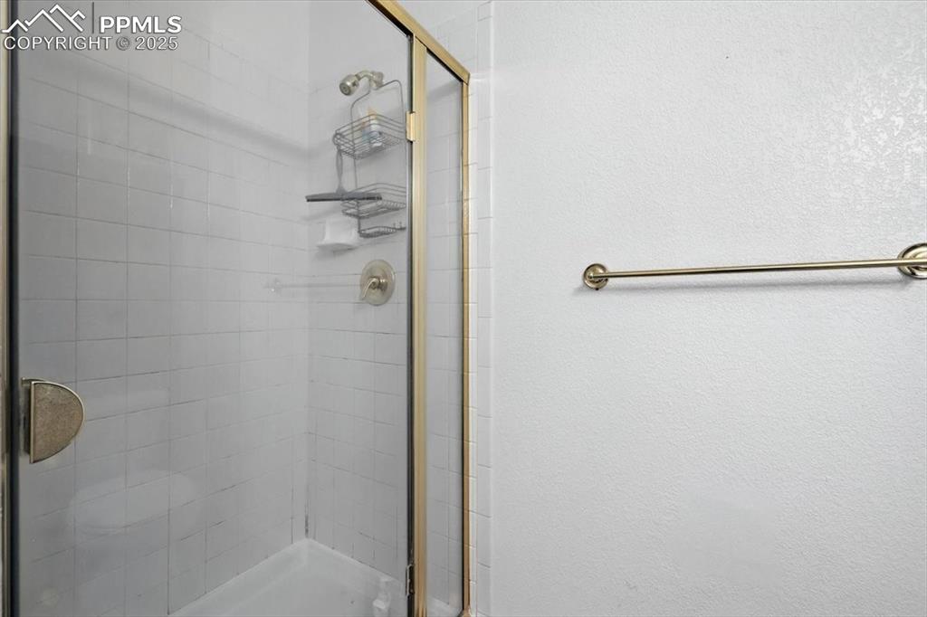 Image 36 of 45: Bathroom featuring a stall shower