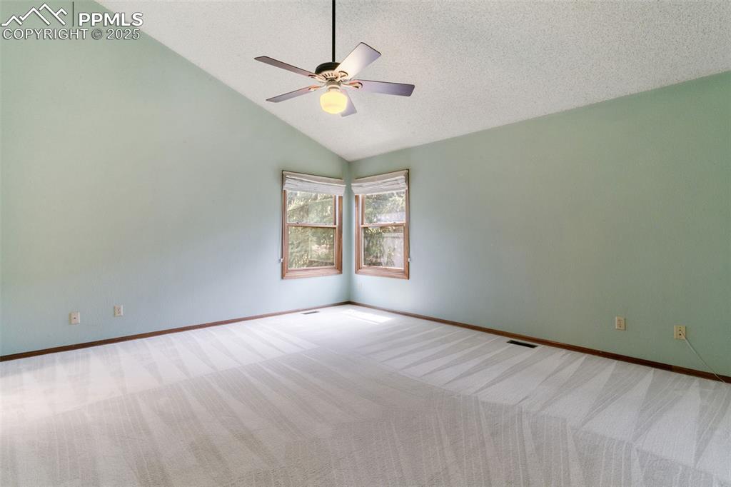 Image 18 of 30: Carpeted spare room featuring a ceiling fan, a textured ceiling, and high v