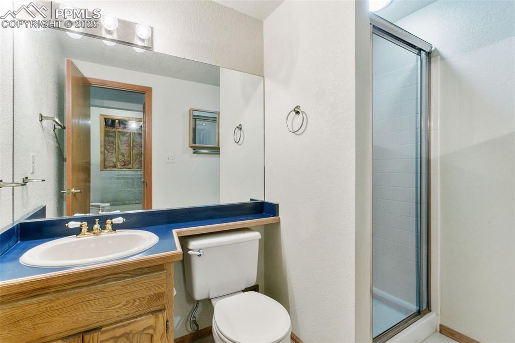 Image 21 of 30: Bathroom with a shower stall and vanity
