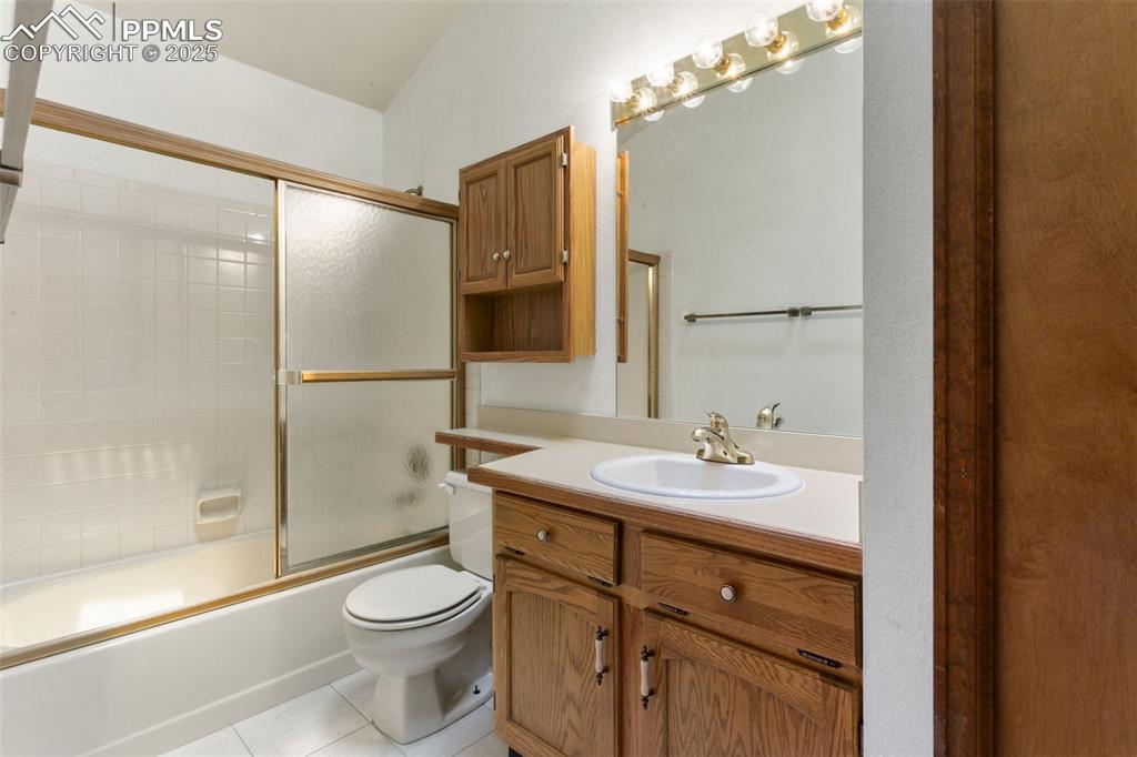Image 27 of 30: Full bath featuring vanity, tile patterned floors, and combined bath / show