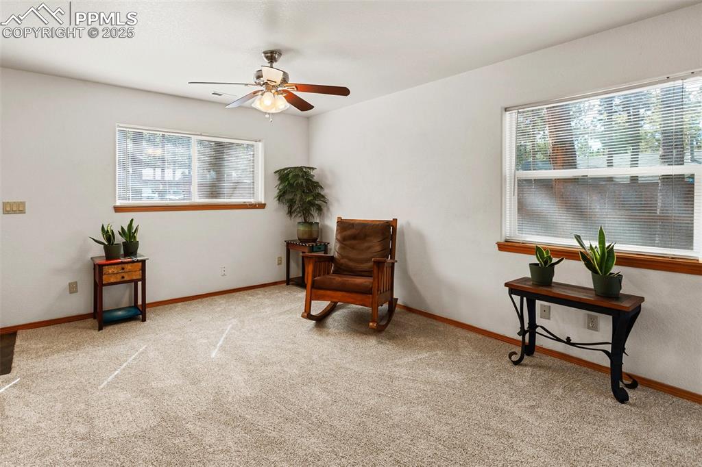 Image 14 of 30: Sitting room featuring light carpet and a ceiling fan