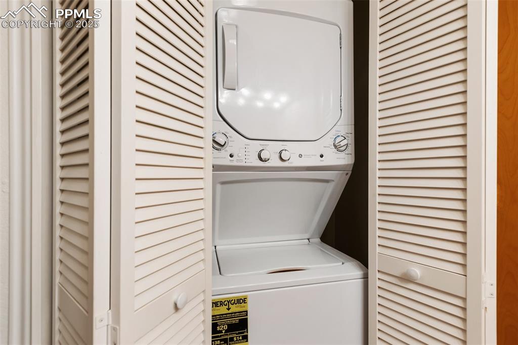 Image 18 of 30: Washroom featuring stacked washer / drying machine