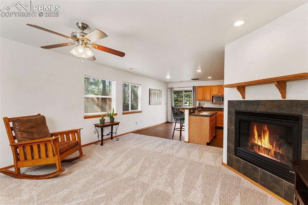 Image 5 of 30: Sitting room featuring recessed lighting, a fireplace, and dark carpet
