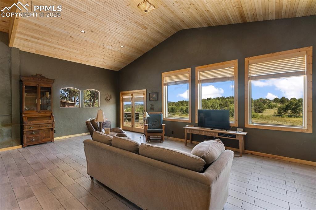 Image 10 of 50: Great room offers open flow to the entire home. High tongue and groove ceil