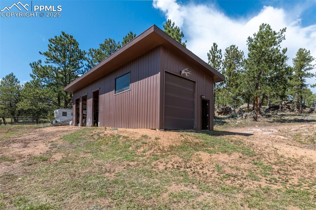 Image 16 of 34: 50 X20 4 car garage with large bay door and man door. Plenty of room for al