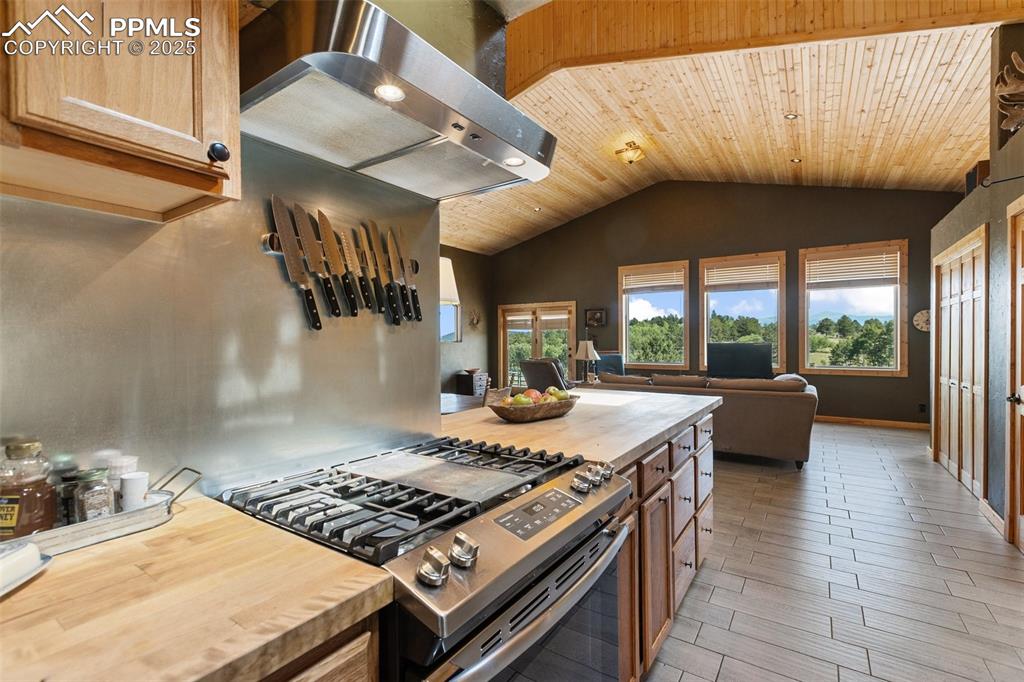 Image 19 of 50: Ceramic flooring, Tiled and Wood countertops.