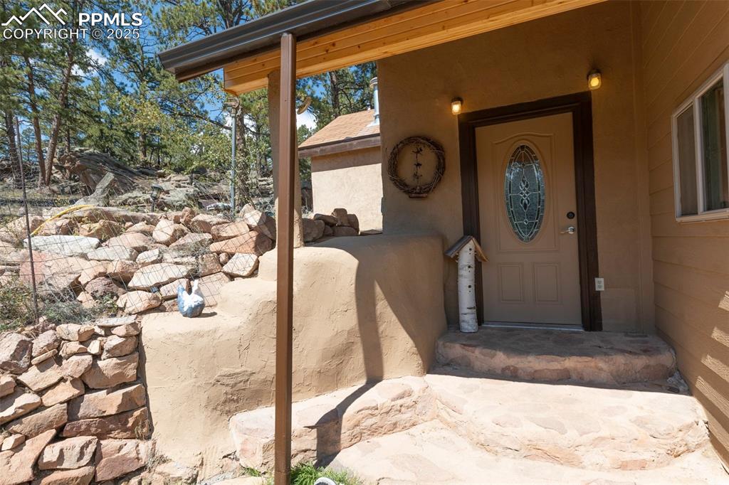 Image 21 of 50: Custom Stonework side entry from the driveway