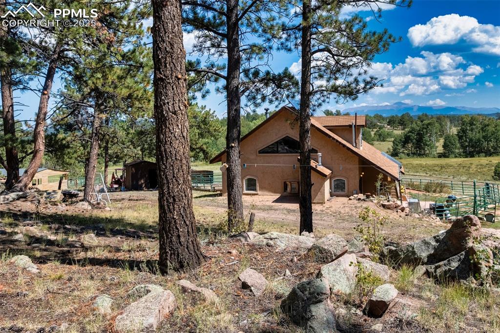Image 3 of 34: West side of the home with Pikes Peak views.