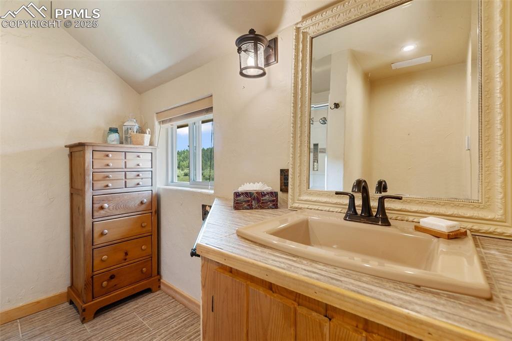 Image 31 of 50: Main level guest bath with walk-in shower.