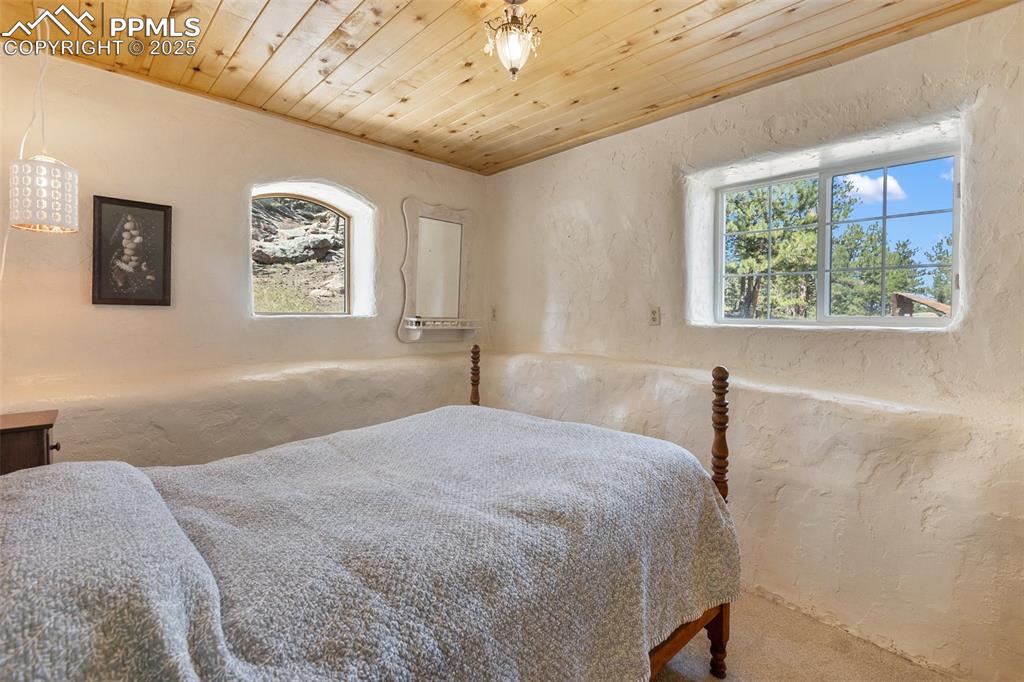 Image 33 of 50: Primary bedroom with look out views across the pasture and to the barn.