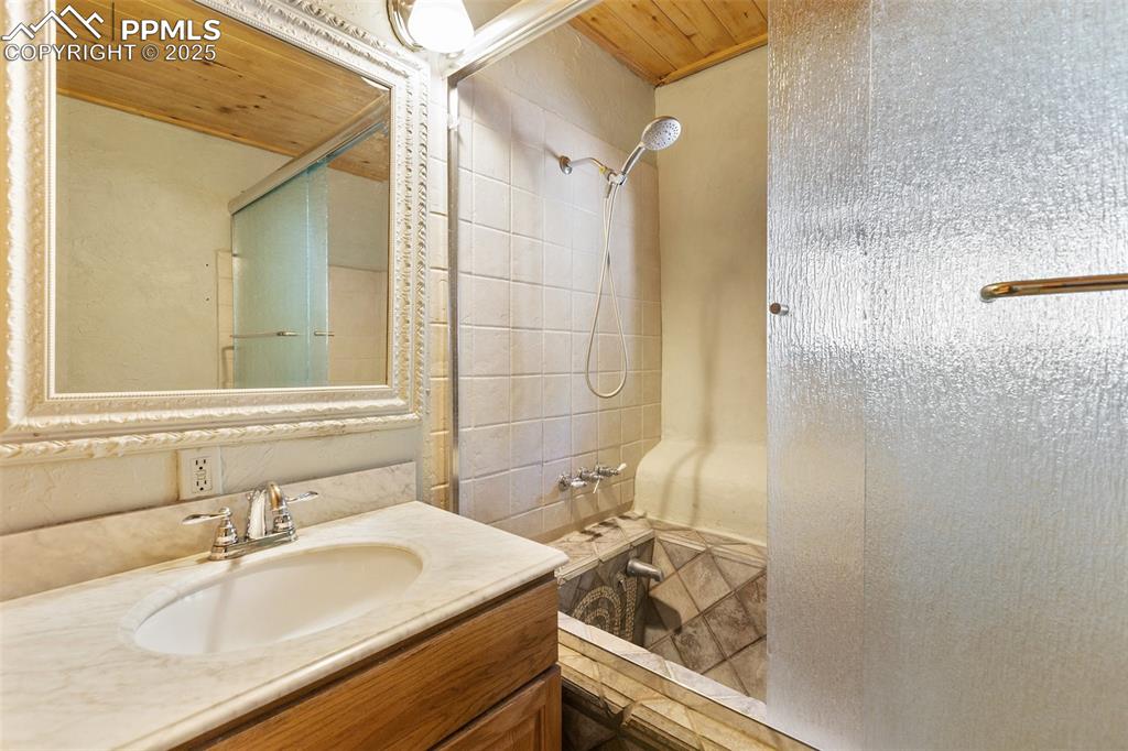 Image 35 of 50: Primary attached full bath. Custom tiled tub.