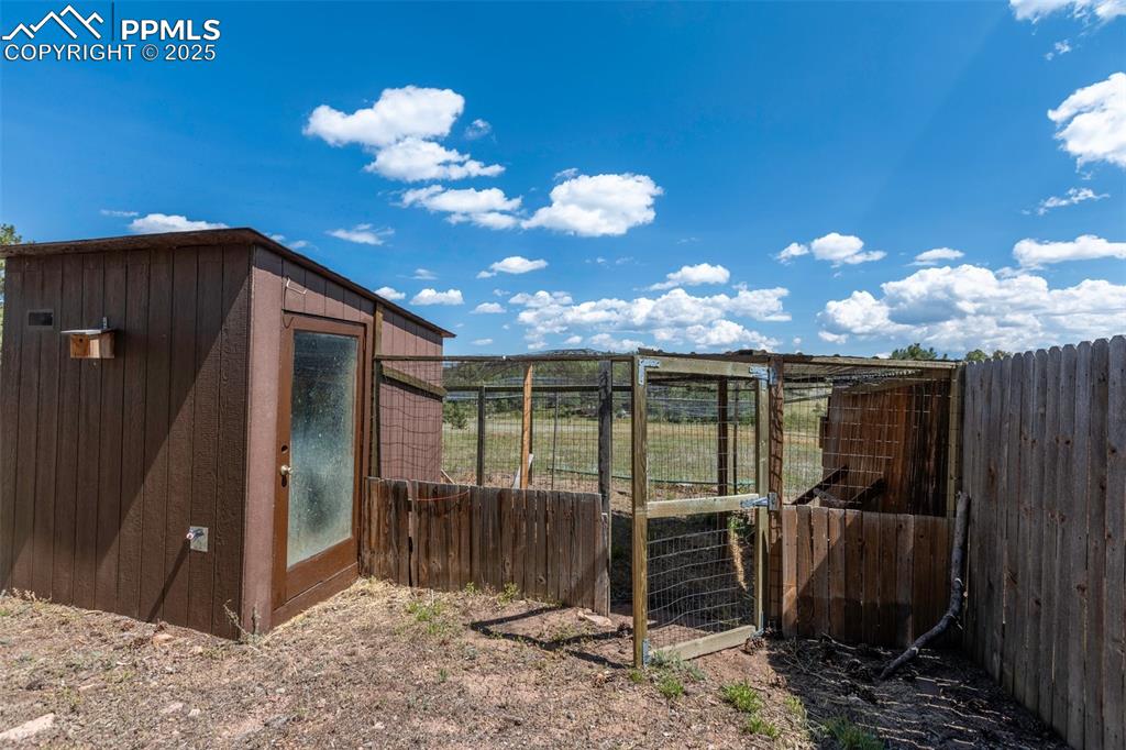Image 44 of 50: Enclosed chicken coop with attached enclosed chicken run.