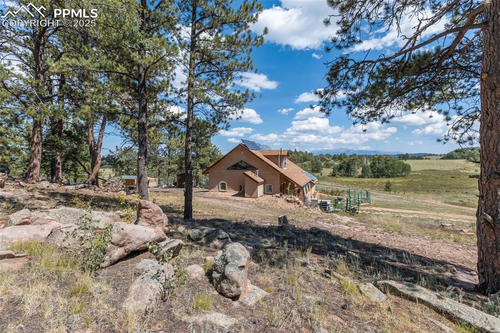 Image 5 of 34: Pikes Peak Views on 10 acres of beautiful pasture land with trees.