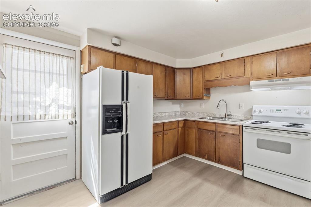 Image 33 of 38: Separate entrance to the basement with a kitchenette.