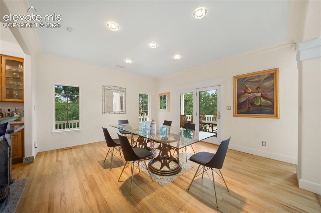 Image 10 of 50: Hardwood flooring throughout, recessed ceiling lighting, multiple windows, 