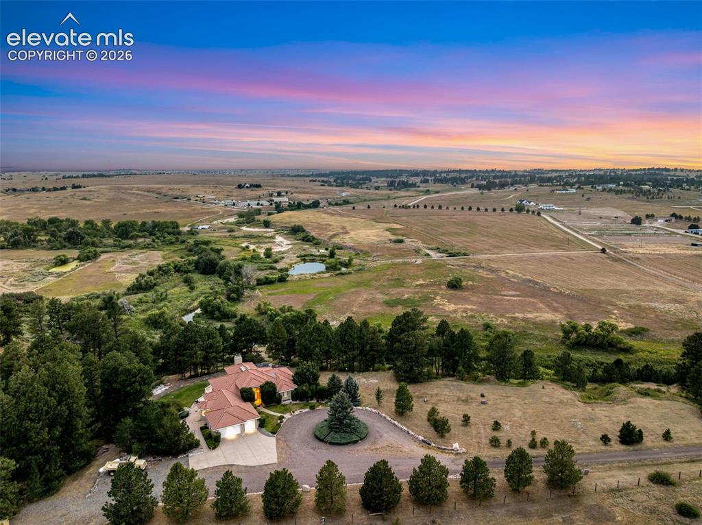 Image 2 of 50: Expansive property featuring a tiled roof residence, a circular driveway, a