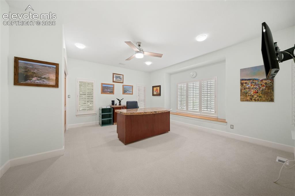 Image 22 of 50: Recessed lighting, ceiling fan, built-in window seat, and plantation shutte