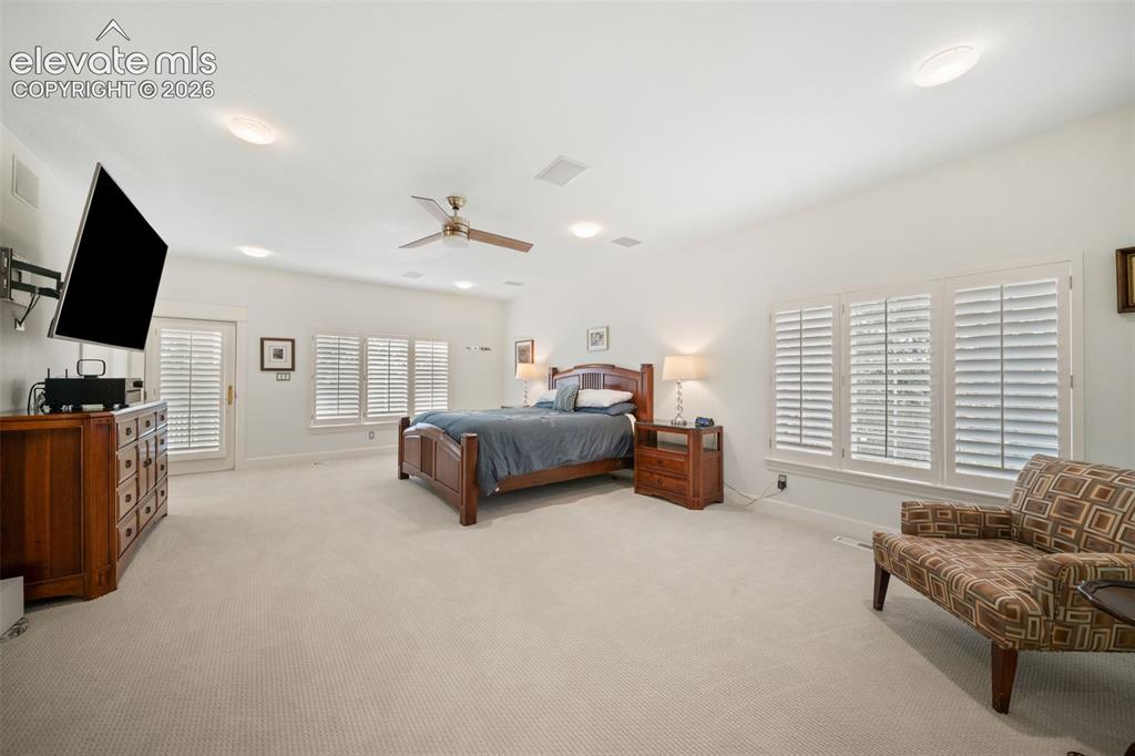 Image 23 of 50: Recessed ceiling lighting, ceiling-mounted speakers, a ceiling fan, and pla