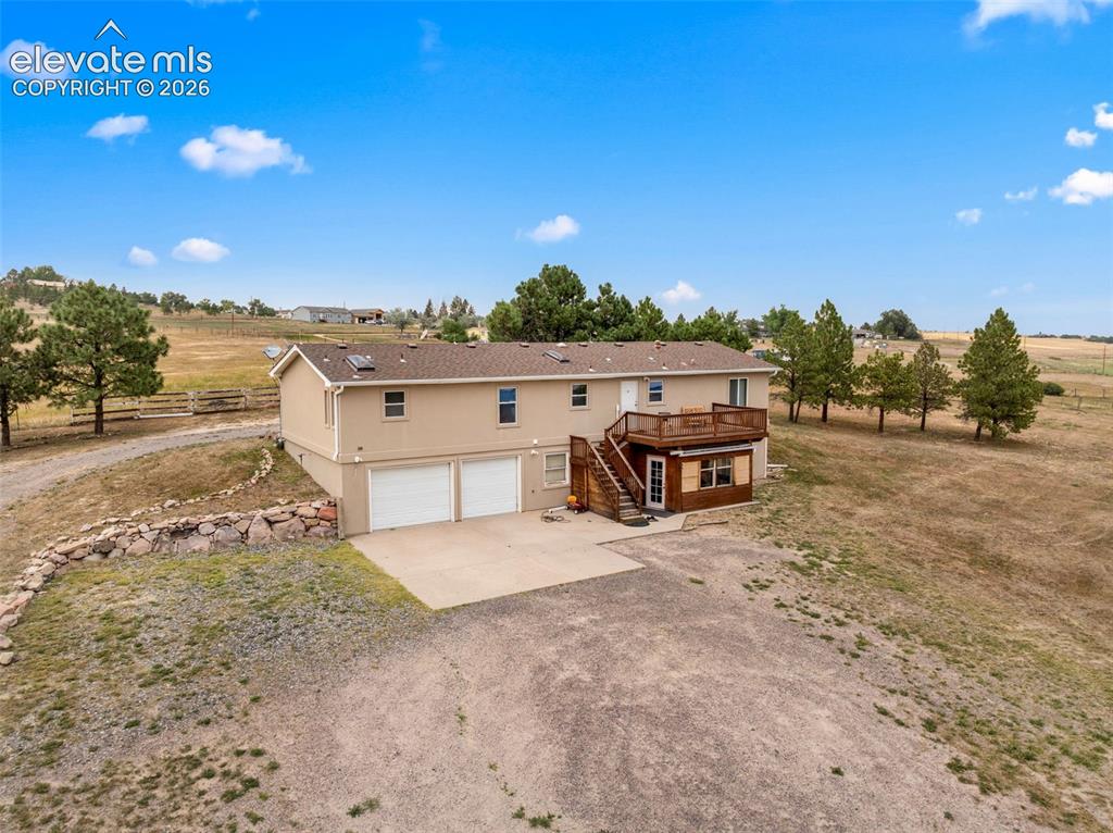 Image 39 of 50: Spacious duplex featuring a two-car attached garage, wood-finish exterior s