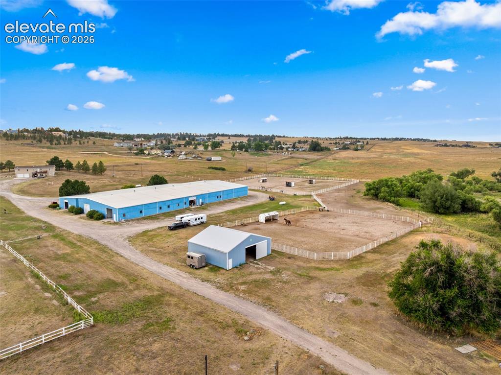 Image 40 of 50: Expansive property featuring multiple outbuildings, fenced paddocks, and a 