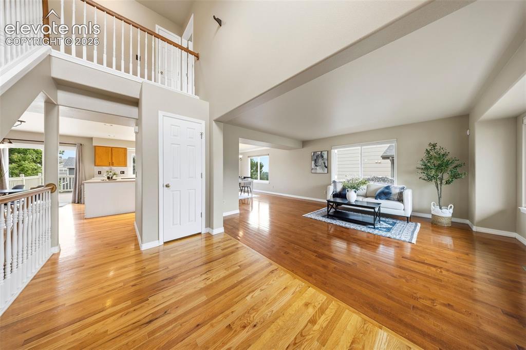 Image 3 of 50: Spacious interior featuring hardwood flooring, a two-story entryway, and a