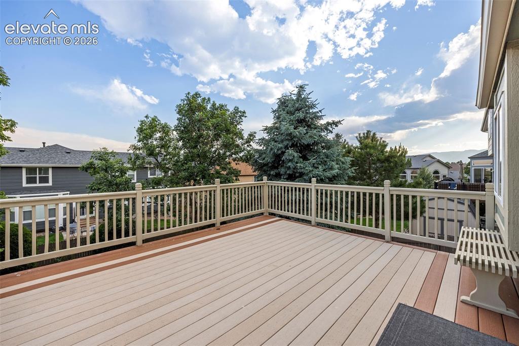 Image 39 of 50: Expansive outdoor deck featuring two-tone composite decking, white railing,