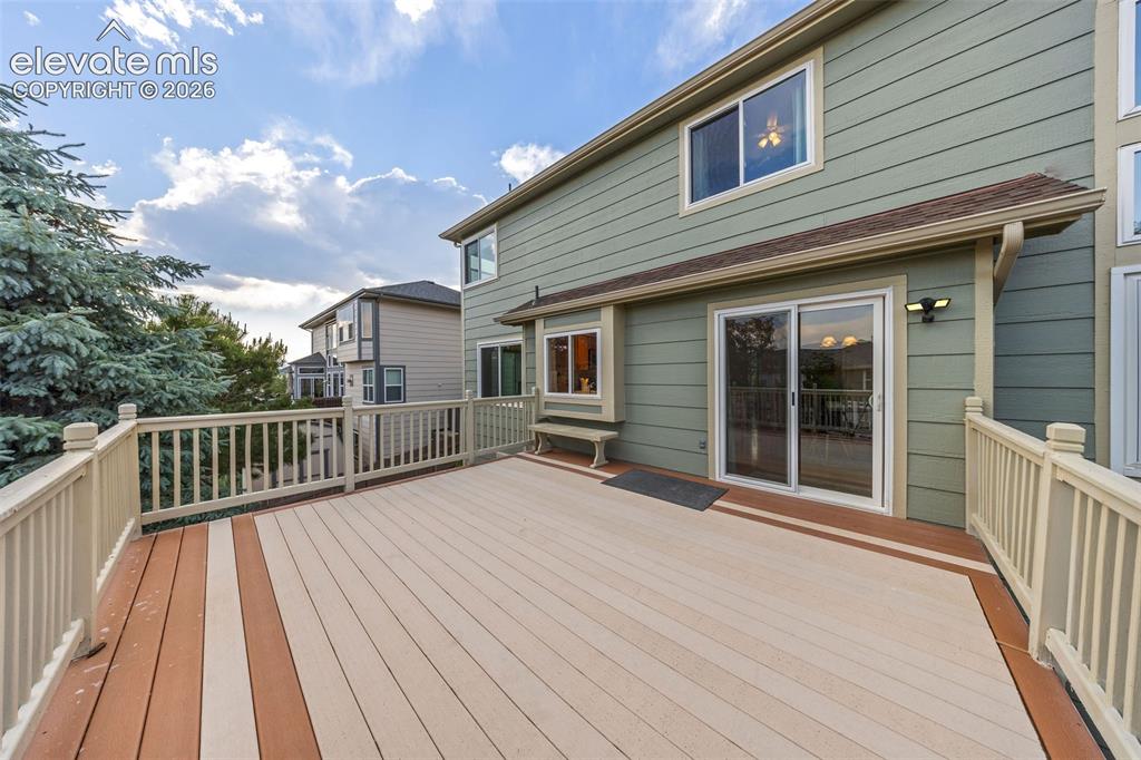 Image 40 of 50: Expansive outdoor deck featuring two-tone composite decking and white raili