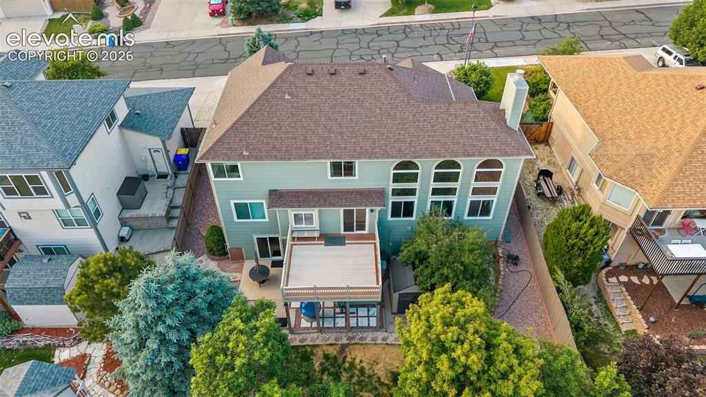 Image 48 of 50: Rear exterior featuring a multi-level deck, ground-level patio, and mature