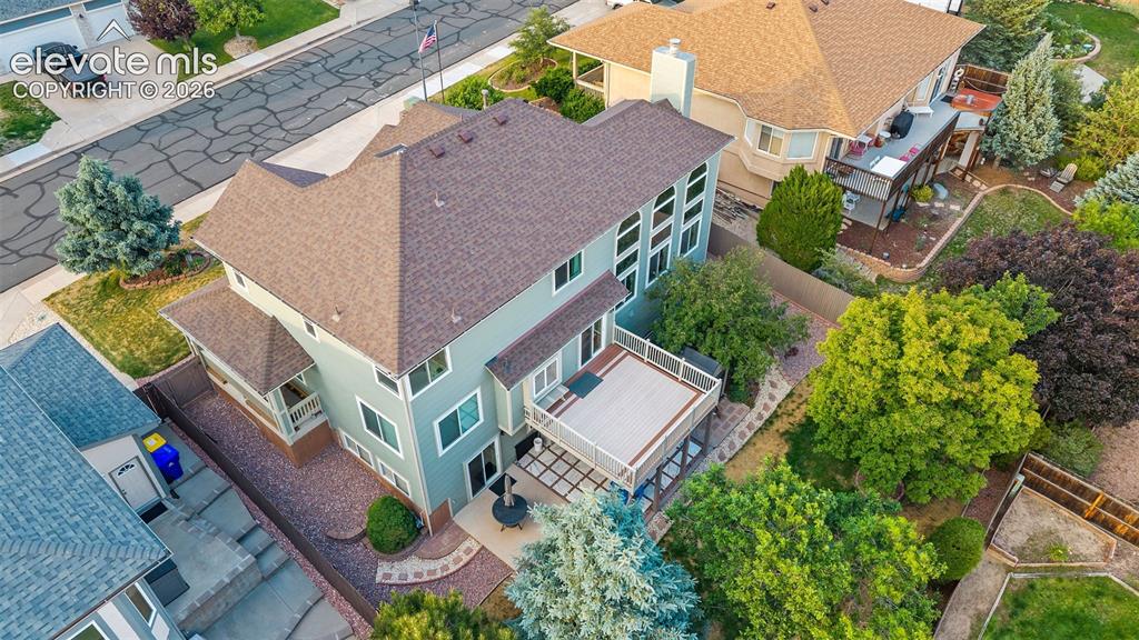Image 49 of 50: Multi-level property featuring a large composite deck with white railings,